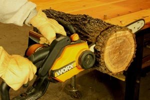 Cutting a log with an electric chainsaw.
